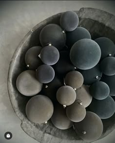 a bowl filled with lots of different colored rocks