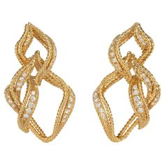 A pair of rope twist gold and diamond earrings designed as open stylized flames, in 18k with clip backs. Chaumet, Paris. Atw diamonds 1.14 cts. One of the oldest continuously operating fine jewelry houses, Chaumet was founded in 1780 by Marie-Étienne Nitot, who had worked for the jeweler to Queen Marie Antoinette before establishing his own Maison. During Napoleon I's reign, Nitot was appointed Imperial court jeweler and soon developed an ardent following among Europe's elite. Control of the Mai Flame Earrings, Gold And Diamond Earrings, Diamond Earrings Design, Rope Twist, Jewelry Workshop, Jewelry Tags, Van Cleef, Clip Earrings, Marie Antoinette