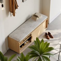 a wooden bench sitting next to a plant and shoes on the floor in front of it