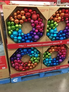 three boxes with ornaments in them on display for sale at the store's christmas decorations