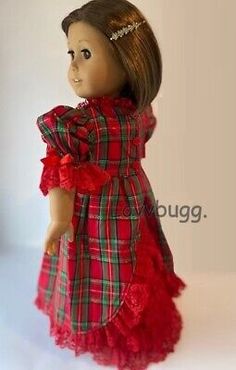 a doll is dressed in red and green plaid