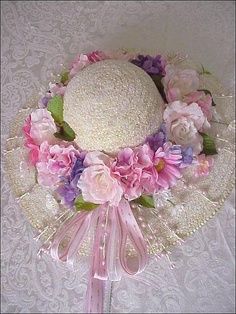 a white hat with pink and purple flowers on it