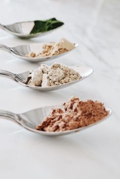 three spoons filled with different types of food