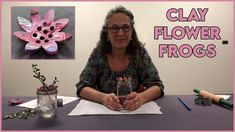 a woman sitting at a table with clay flowers and mason jars in front of her