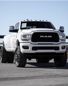 a white ram truck parked on top of a parking lot