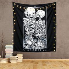 a wall hanging with a skeleton and flowers on it