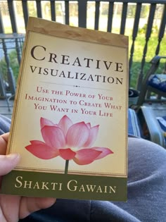 a person holding up a book in their hand that reads creative visualization use the power of your imagination to create what you want in your life