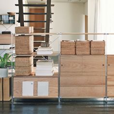 the shelves are filled with boxes and baskets on them, along with other items such as bookshelves