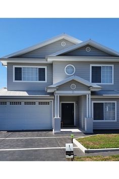 a large house with two garages in front of it