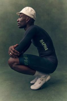 a man sitting on top of a green floor