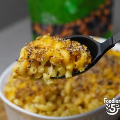 a spoon full of macaroni and cheese on a table