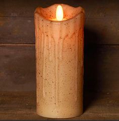 a lit candle sitting on top of a wooden table