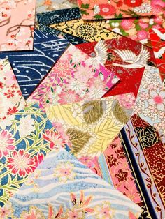 many different types of fabric with flowers and birds on them, all in various colors