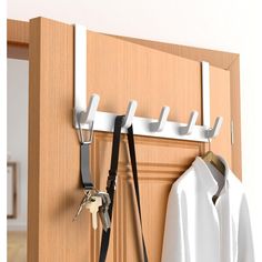 there is a coat rack with two keys on it and a pair of suspenders hanging from the hooks