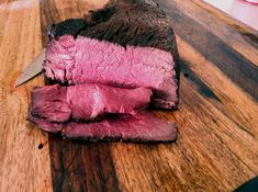 a piece of meat on a cutting board with a knife