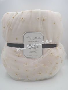 the back of a white blanket with gold stars on it and a label that says honey & bubbles