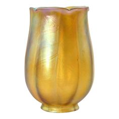 a gold colored vase is shown against a white background