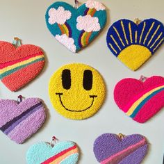 six handmade heart shaped brooches with different colors and designs on the backs