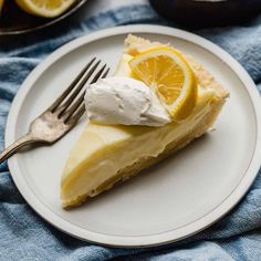 a slice of lemon pie on a plate with a fork