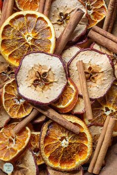 sliced oranges and cinnamon sticks on a table