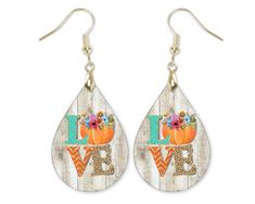 "Fall Pumpkin Teardrop Earrings -Earrings are made of hardboard with a glossy surface -Design is heat pressed onto the hardboard surface. Hardboard is an engineered wood. -Faux barnwood design, not actual barnwood -The teardrops are 1.5\" long, 1\" wide and 1/8\" thick -Hardware as shown - these have a gold color earwire -Includes fishhook earwires with rubber earrring stoppers -Hand printed, pressed and assembled." Teardrop Earrings Fall, Fall Resin Earrings, Harvest Earrings, Fall Leaf Earrings, Pumpkin Spice Latte Earrings, Large Statement Earrings, Laser Engraved Ideas, Sunflower Earrings, Earrings Handmade Dangle