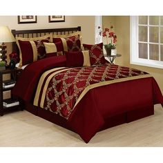 a bed with red and beige comforters in a room