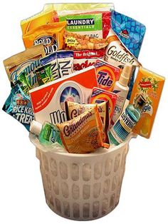 a white basket filled with snacks and candy bar mix in it's bottom half