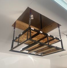 the suspended light fixture is made from metal and wood