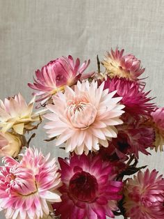 a vase filled with lots of pink and white flowers