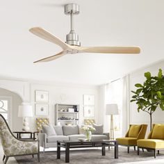 a living room with couches, chairs and a ceiling fan in the middle of it