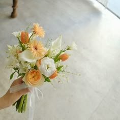 a person holding a bouquet of flowers in their hand