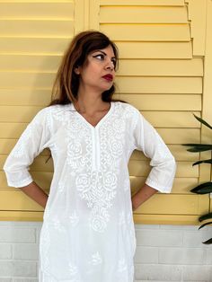 Introducing our White Women's Chikankari Kurta Long, a stunning fusion of style and comfort designed for warm weather elegance. This airy and lightweight Indian cotton white kaftan dress is your perfect companion on scorching summer days. What's more, the softness of this cotton kurta only deepens with each wash, ensuring a delightful wearing experience. This hand-embroidered beauty isn't just a piece of clothing; it's an ideal choice for functions and parties. Whether you're aiming for a classi White V-neck Kaftan For Spring, Spring V-neck Kurta With Chikankari Embroidery, V-neck Kurta With Chikankari Embroidery For Spring, V-neck Tunic With Chikankari Embroidery For Spring, Flowy White Top For Beach Cover-up, White Cotton Relaxed Fit Kurta, White Cotton Kurta With Relaxed Fit, White Relaxed Fit Cotton Kurta, White Casual Kurta With Relaxed Fit