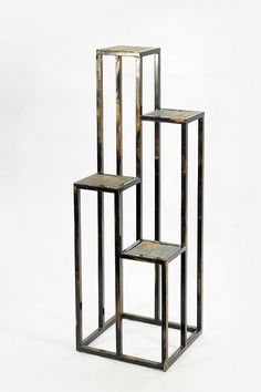 three metal and wood shelvings stacked on top of each other in the shape of cubes