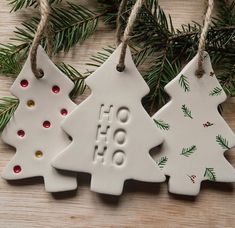 three ceramic christmas ornaments hanging from a tree