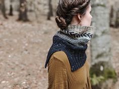 a woman wearing a scarf in the woods