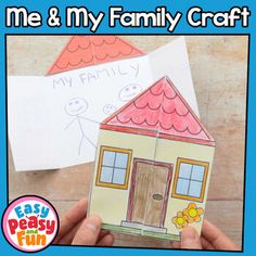 a hand holding up a paper house with the words me and my family craft on it