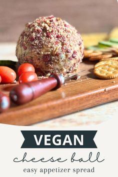 A side view of a vegan cheese ball placed on a wooden surface, surrounded by an assortment of crackers and fresh vegetables. Vegan Cheese Ball, Easy Vegan Cheese, Holiday Party Game, Vegan Appetizer, Dairy Free Cheese, Vegan Appetizers