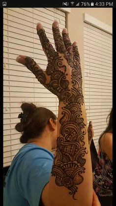 a woman is showing off her henna tattoo