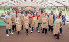 a group of people in aprons posing for a photo