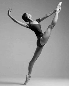 a ballerina in black and white poses for the camera