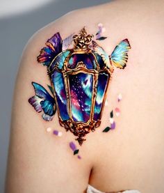 the back of a woman's shoulder with butterflies on it and a light fixture