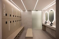 an empty locker room with several sinks and mirrors on the wall next to each other