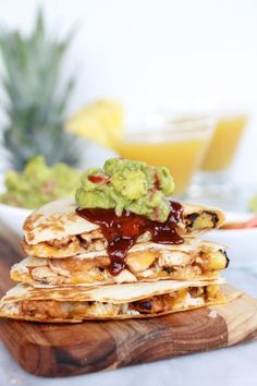 a stack of quesadillas with guacamole and salsa on top