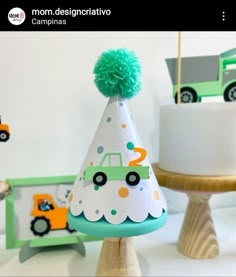 a party hat with a green pom - pom on top sits next to other decorations