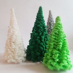 three small christmas trees sitting next to each other