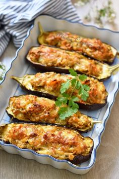 baked eggplant stuffed with meat and garnished with cilantro sauce