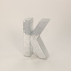 the letter k is made up of silver squares