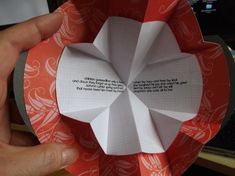 someone is holding an origami piece with a quote on it in their hand