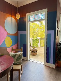 an open door leading into a colorful room