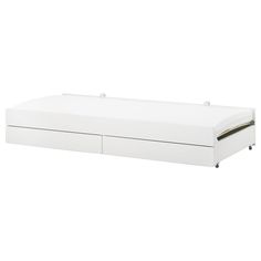 a white bed with two drawers on the bottom and one drawer open to reveal a mattress